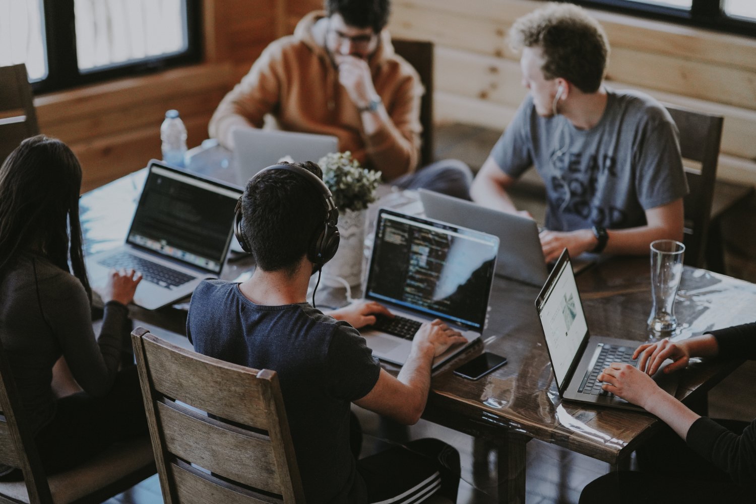 Group of people behind laptop